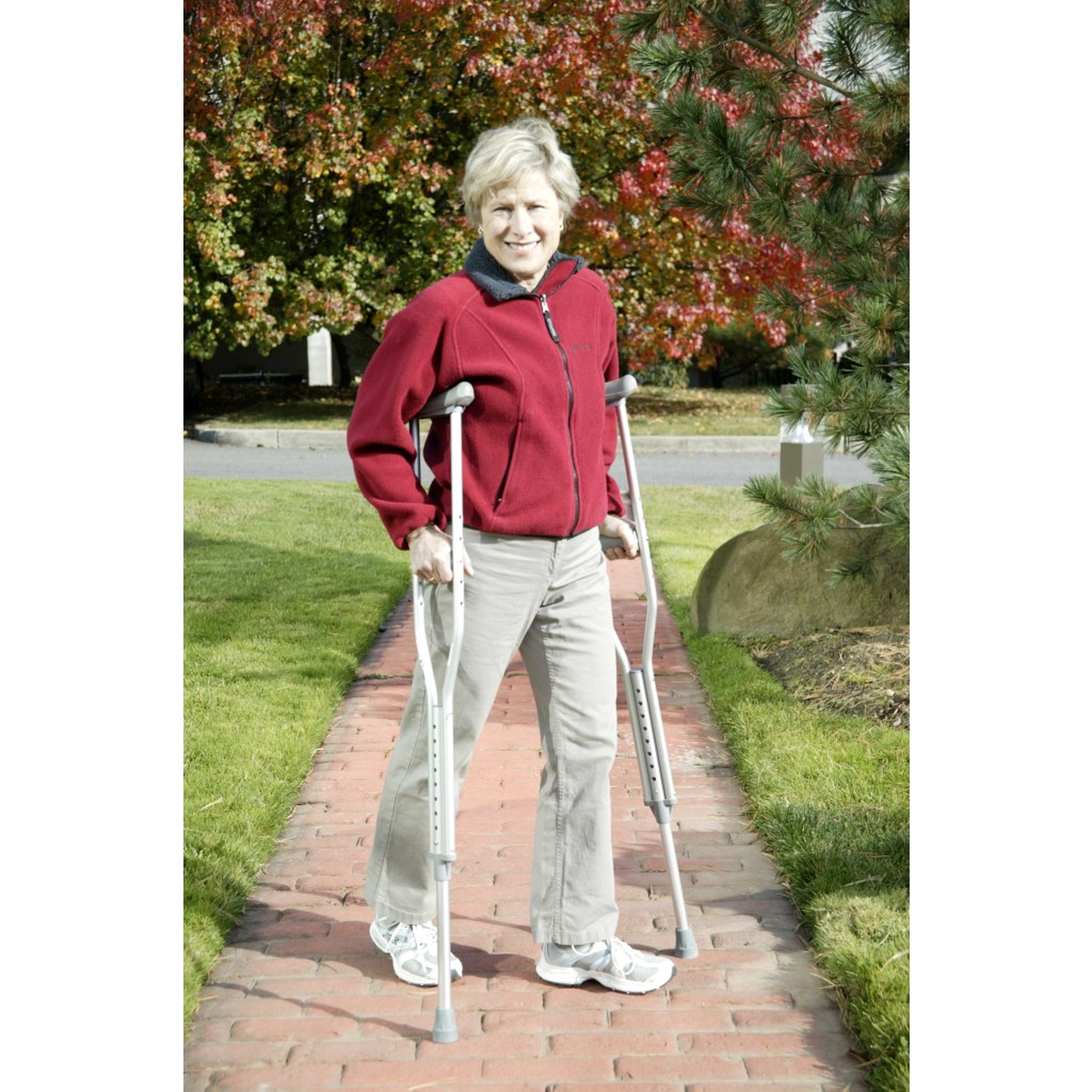 Woman using Drive Medical aluminum underarm crutches outdoors